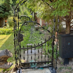 Hand-forged gate with a spiderweb and spider – designer gate Hand-forged gate with a spiderweb and spider – designer gate